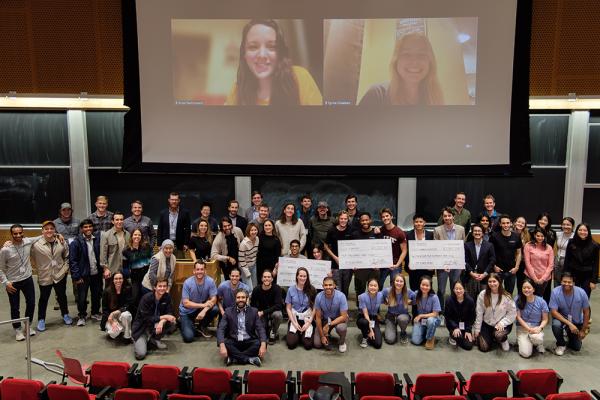 Energy and Climate Hack participants, in person and virtually, gather for a photo.