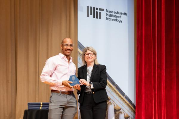 Benjamin Lewis (left), a graduate student in the Institute for Data, Systems and Society in the MIT Schwarzman College of Computing, was the 2024 recipient of the Collier Medal for his work as founder of the Cambridge branch of End Overdose, a nonprofit dedicated to reducing drug-related overdose deaths. MIT President Sally Kornbluth presented his award at the ceremony. 