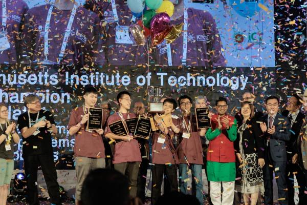 MIT's competitive programming team, wearing maroon T-shirts, are (left to right) student coach Ce Jin, undergraduates Jerry Mao and Mingyang Deng, and Xiao Mao ’21 MEng ’22.