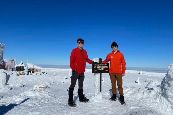 Nathanael Jenkins (left) and Timur Uyumaz pose atop Mt. Washington on a warm winter's day.